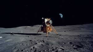 Astronaut Buzz Aldrin in white spacesuit on the Moon with lunar module Eagle and Neil Armstrong reflected in helmet visor